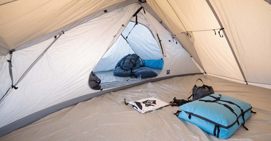 Spacious interior of the Hyperlite Mountain Gear Ultamid 2-Person Tent, showing two people sitting comfortably with gear