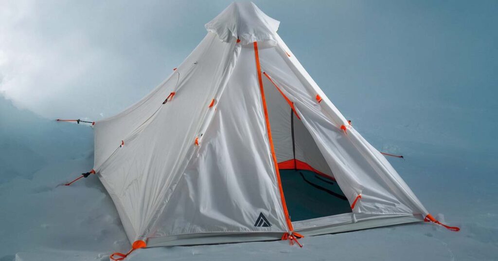 Hyperlite Mountain Gear Ultamid 2-Person Tent set up in a high-altitude mountain environment, showcasing its pyramid design and weather resistance